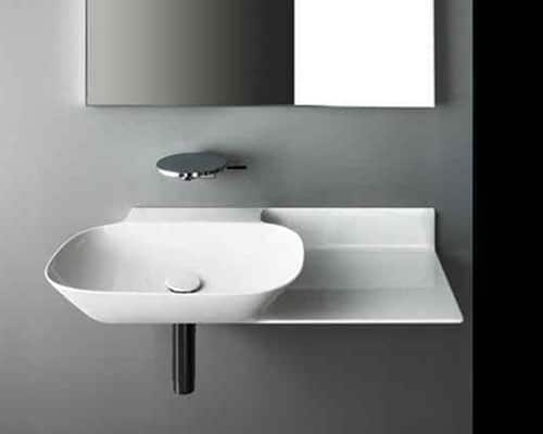 A wall-hung basin on a grey wall