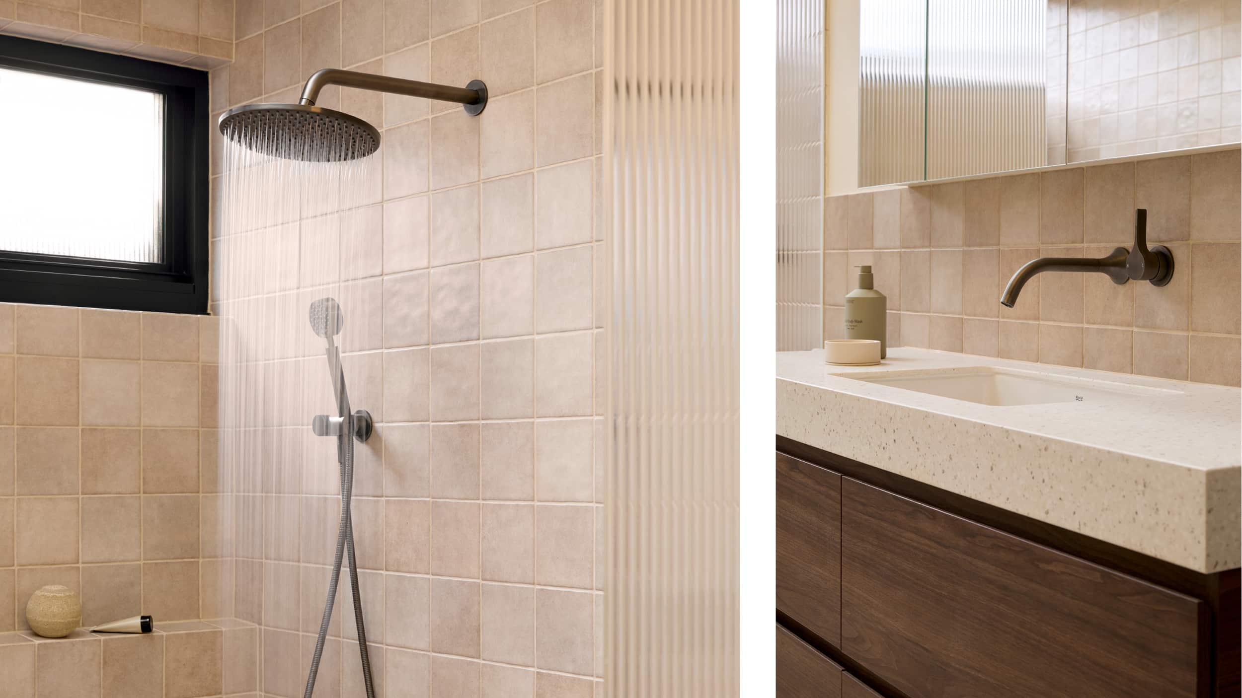 A spa-like bathroom featuring blush tile, expansive shower with fluted glass screen, timber vanity and brushed gunmetal fixtures
