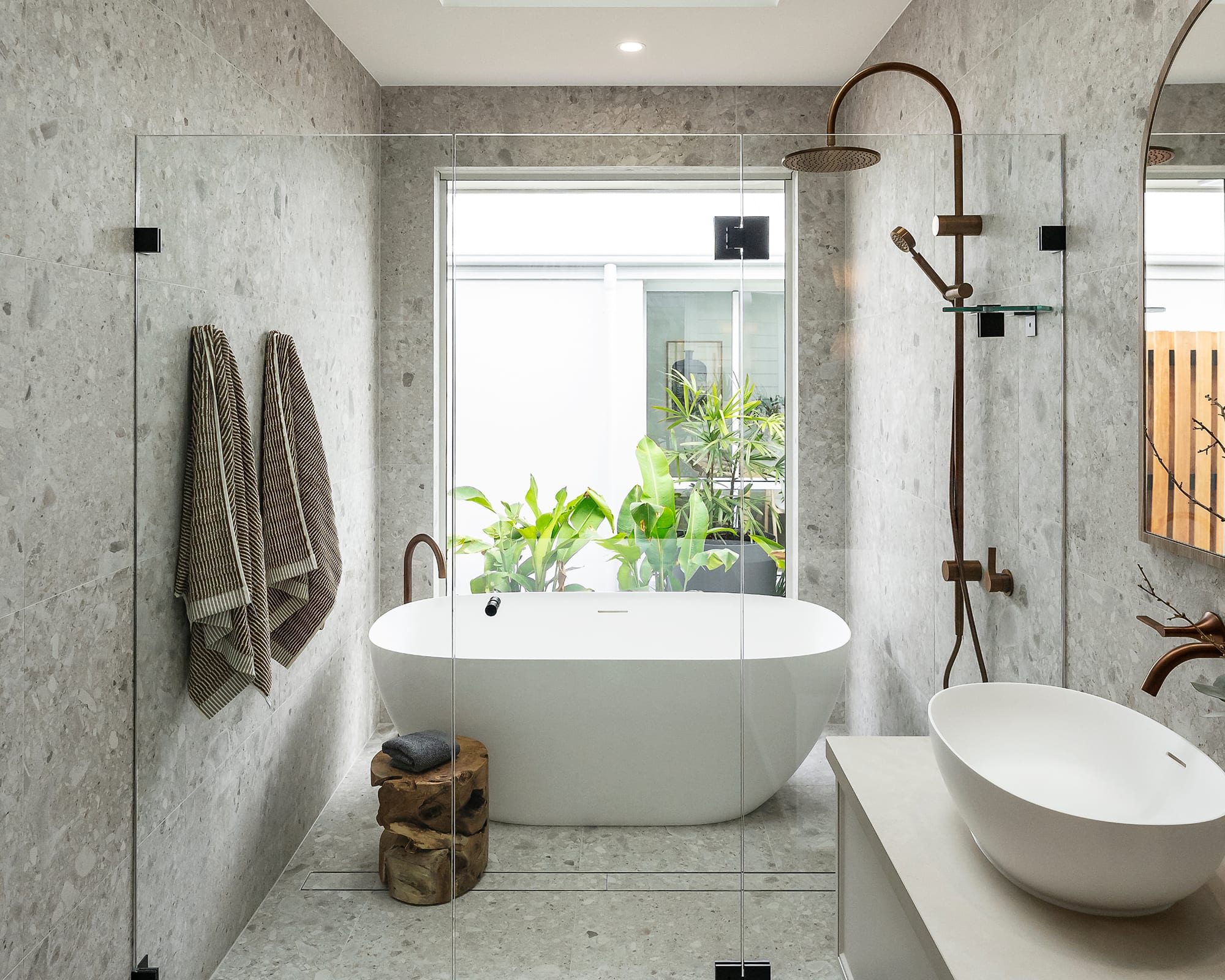 A contemporary bathroom showcasing a glass shower door next to a relaxing bathtub.