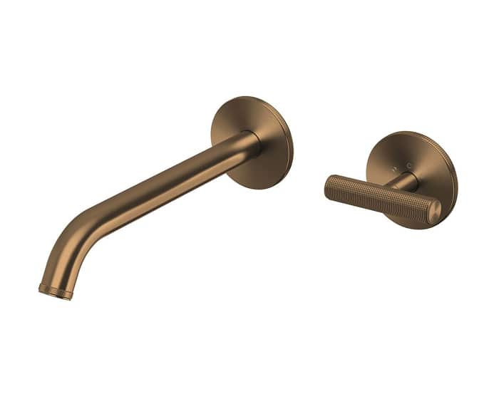 A wall basin outlet and mixer in brushed bronze