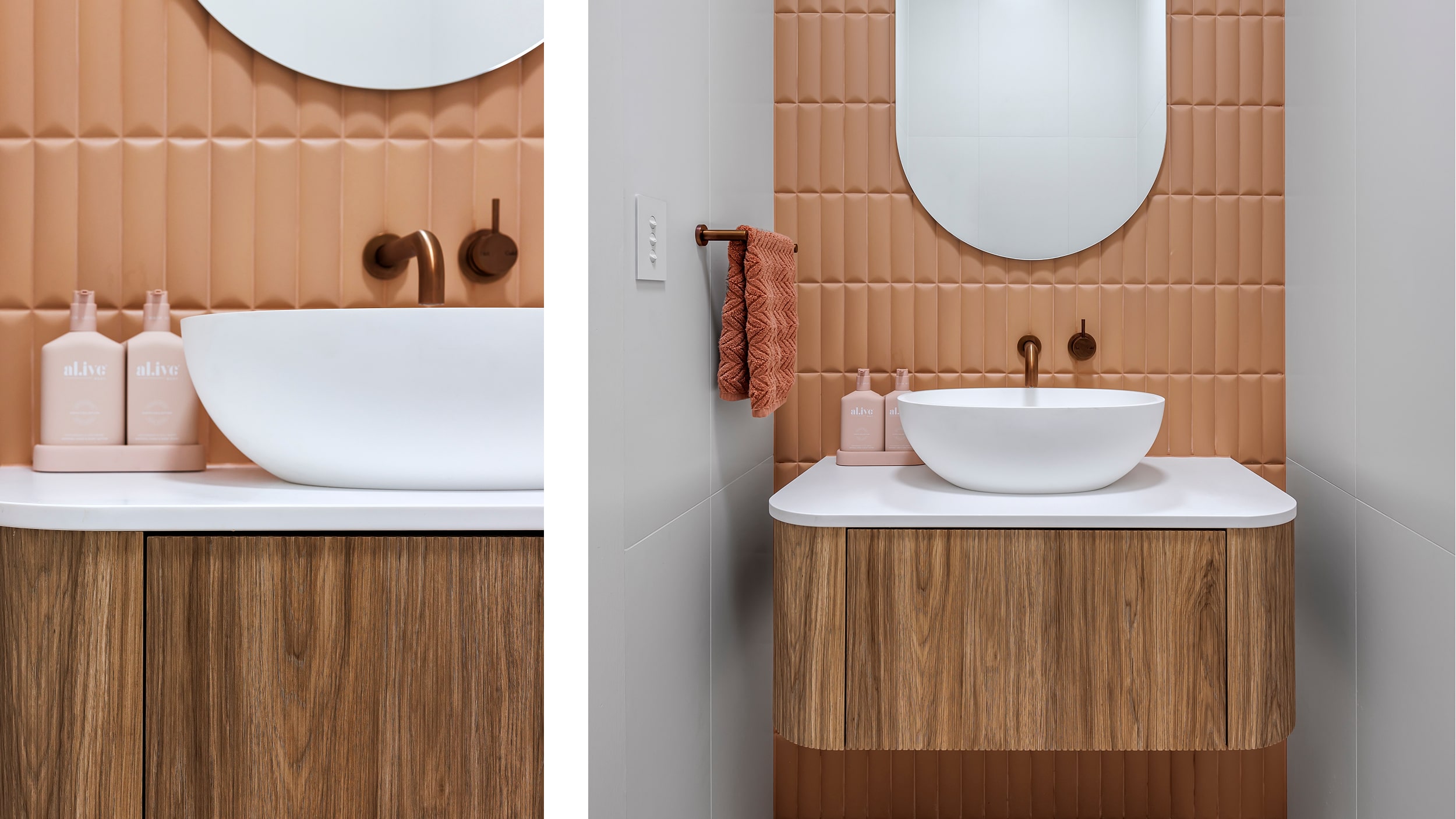A modern bathroom basin with a round mirror above, peach-colored tile backsplash, brown faucet, and pink soap dispensers on a wood vanity.