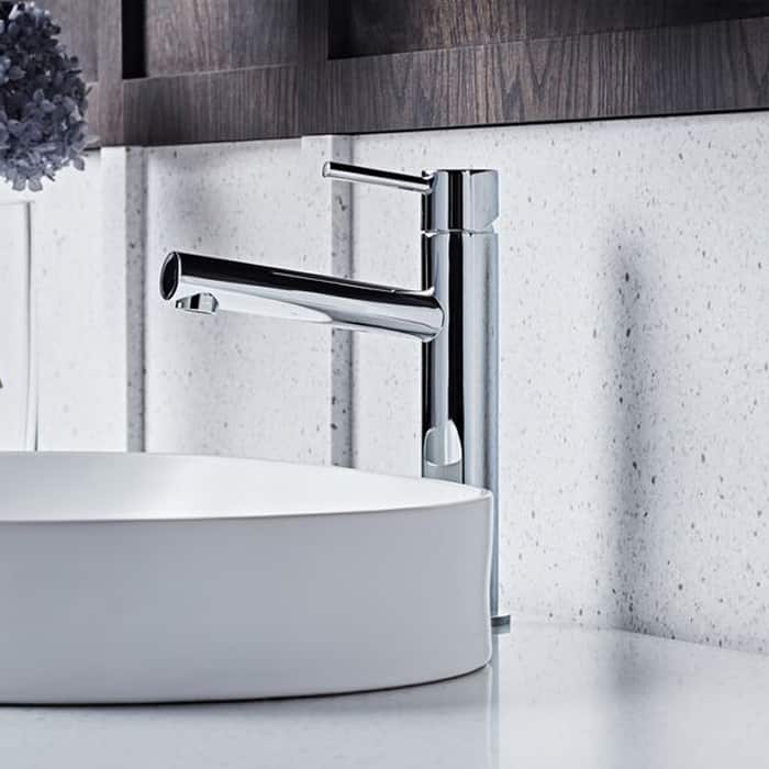 A chrome basin mixer and white basin