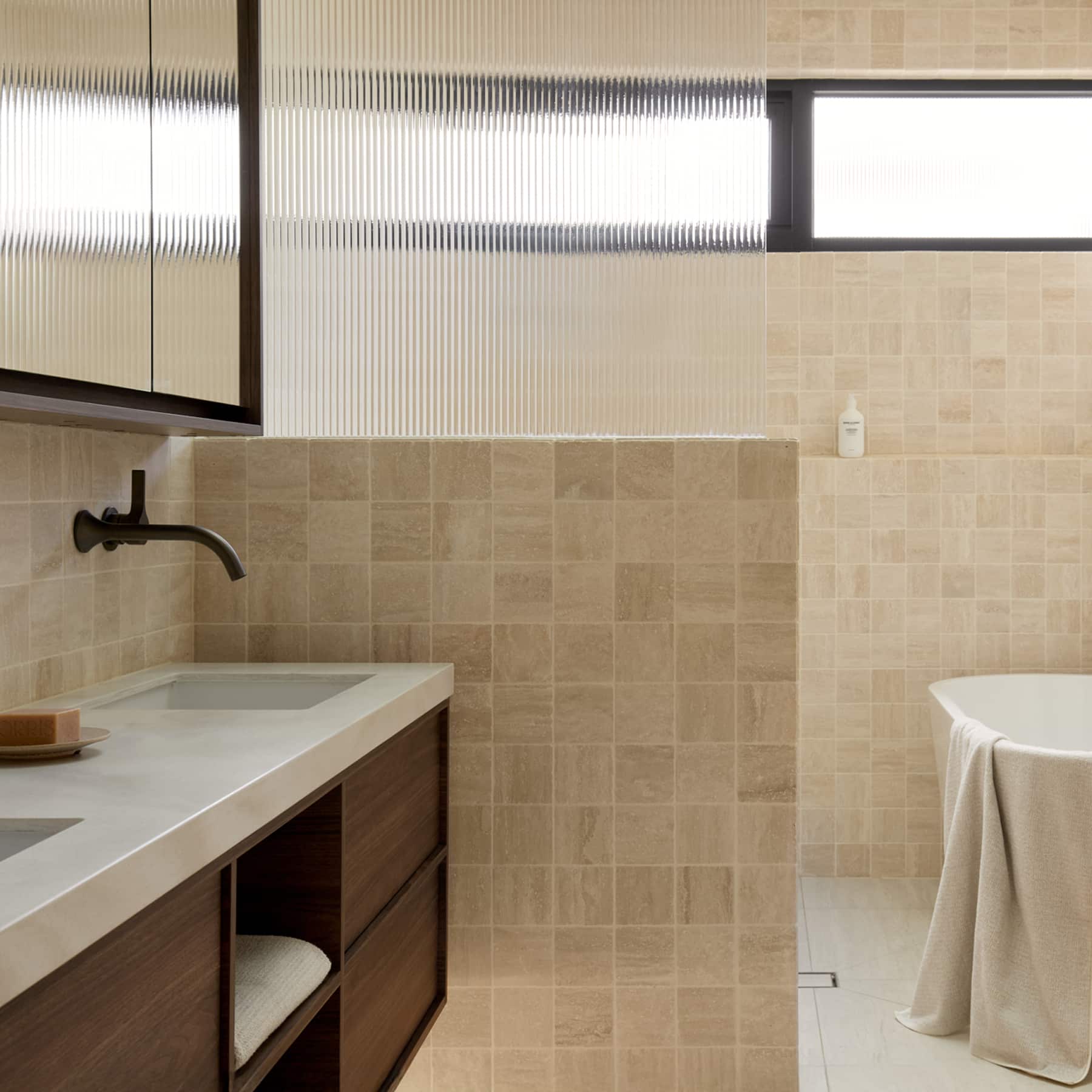 A luxurious bathroom featuring timber vanity, expansive walk-in shower and bath