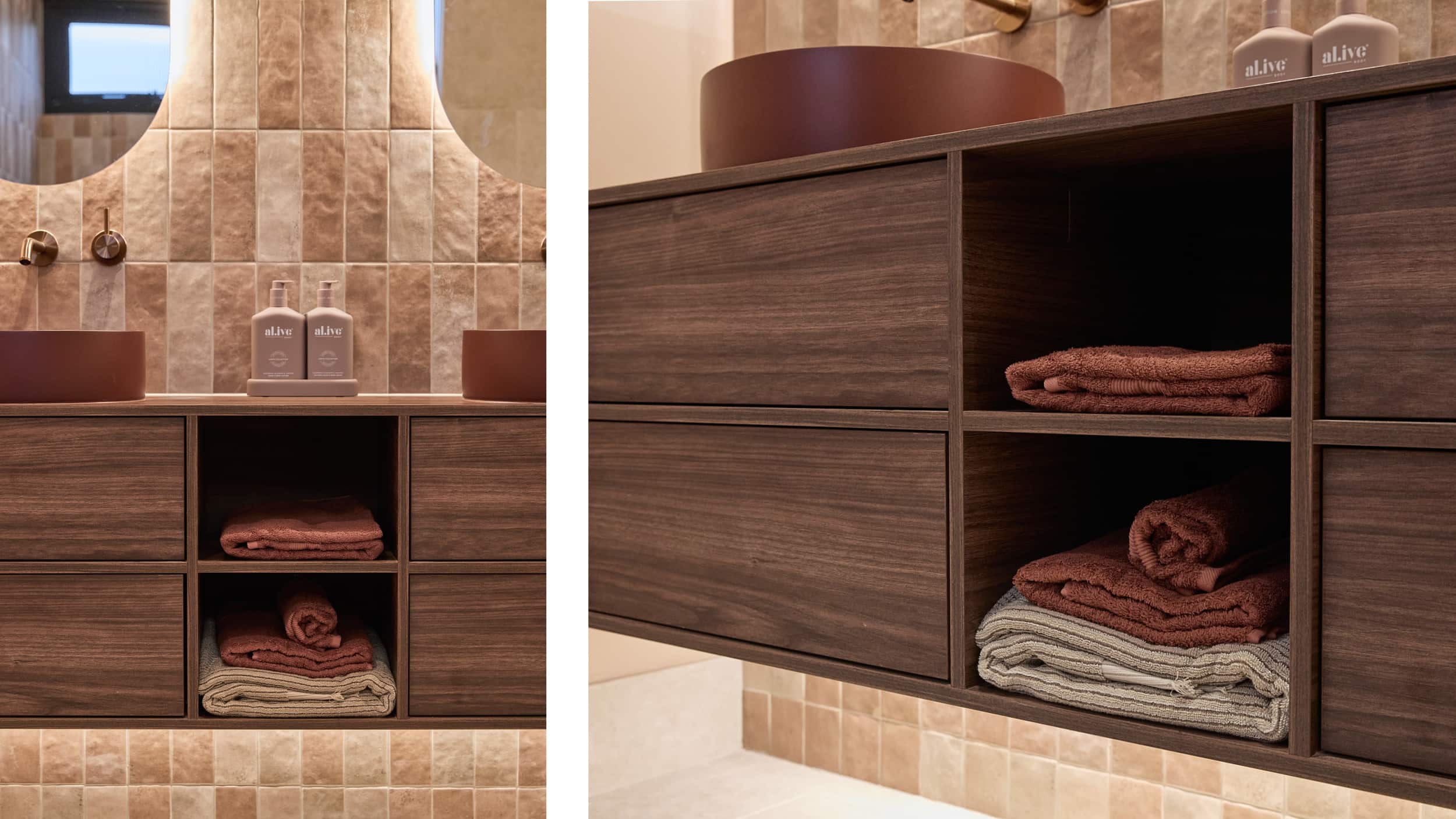 A dark timber vanity, maroon-coloured basins on a soft pink-tiled wall