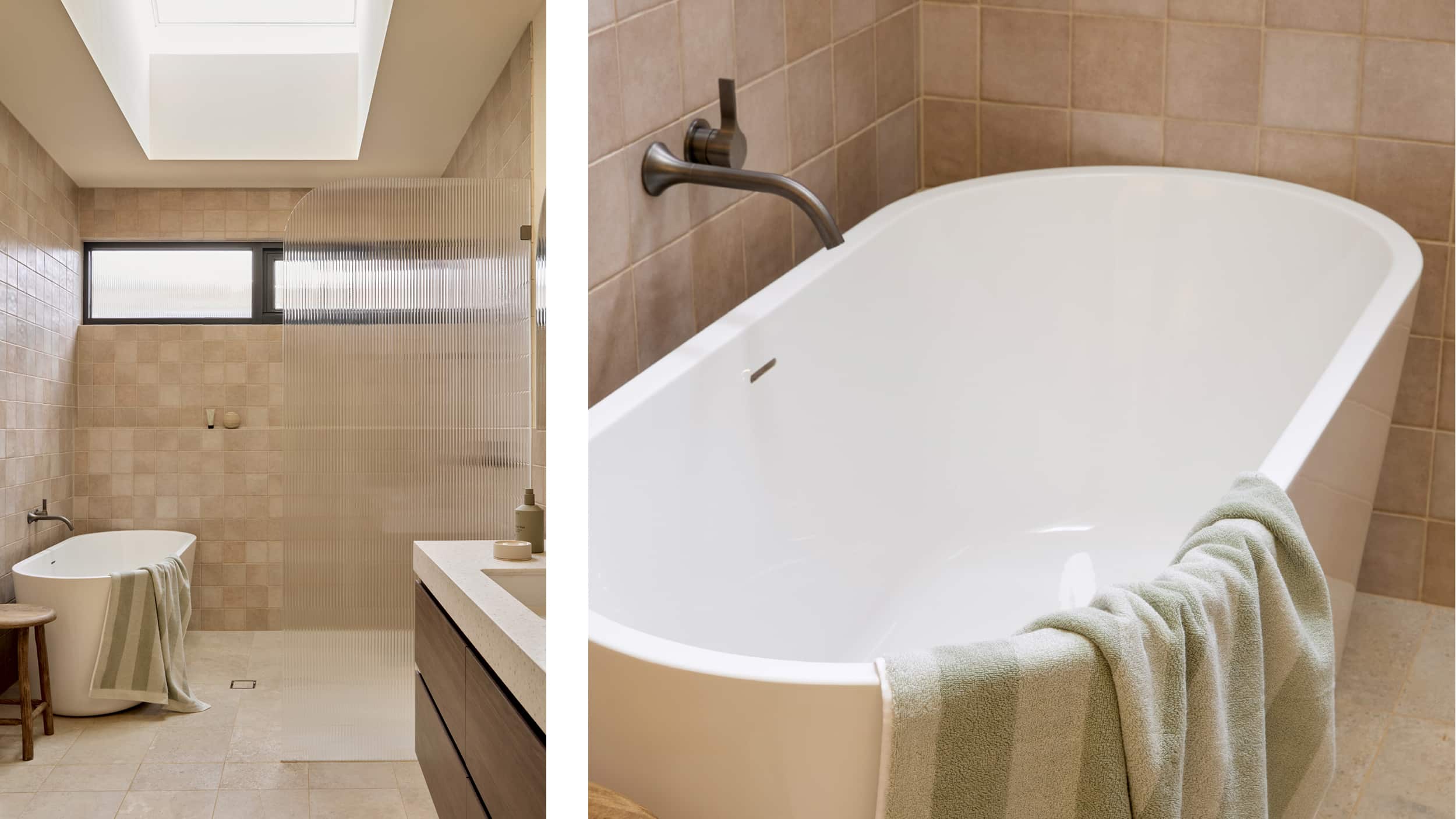 A spa-like bathroom featuring blush tile, freestanding bath next to an expansive shower with fluted glass screen, and timber vanity