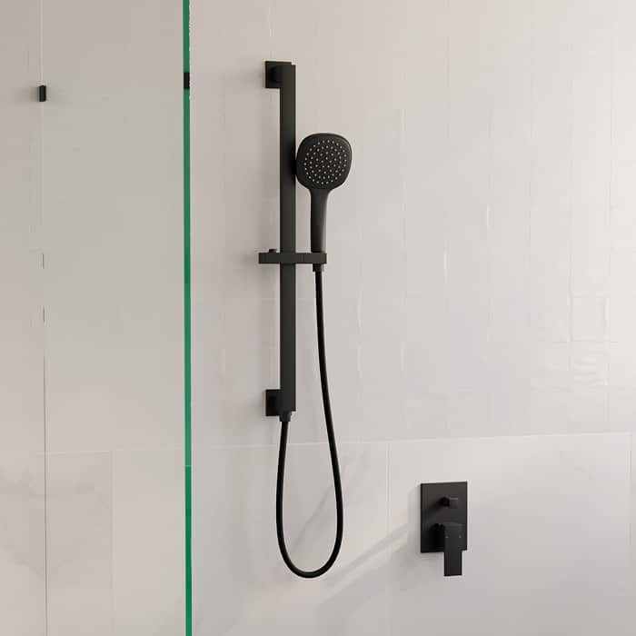 A black rail shower with handshower