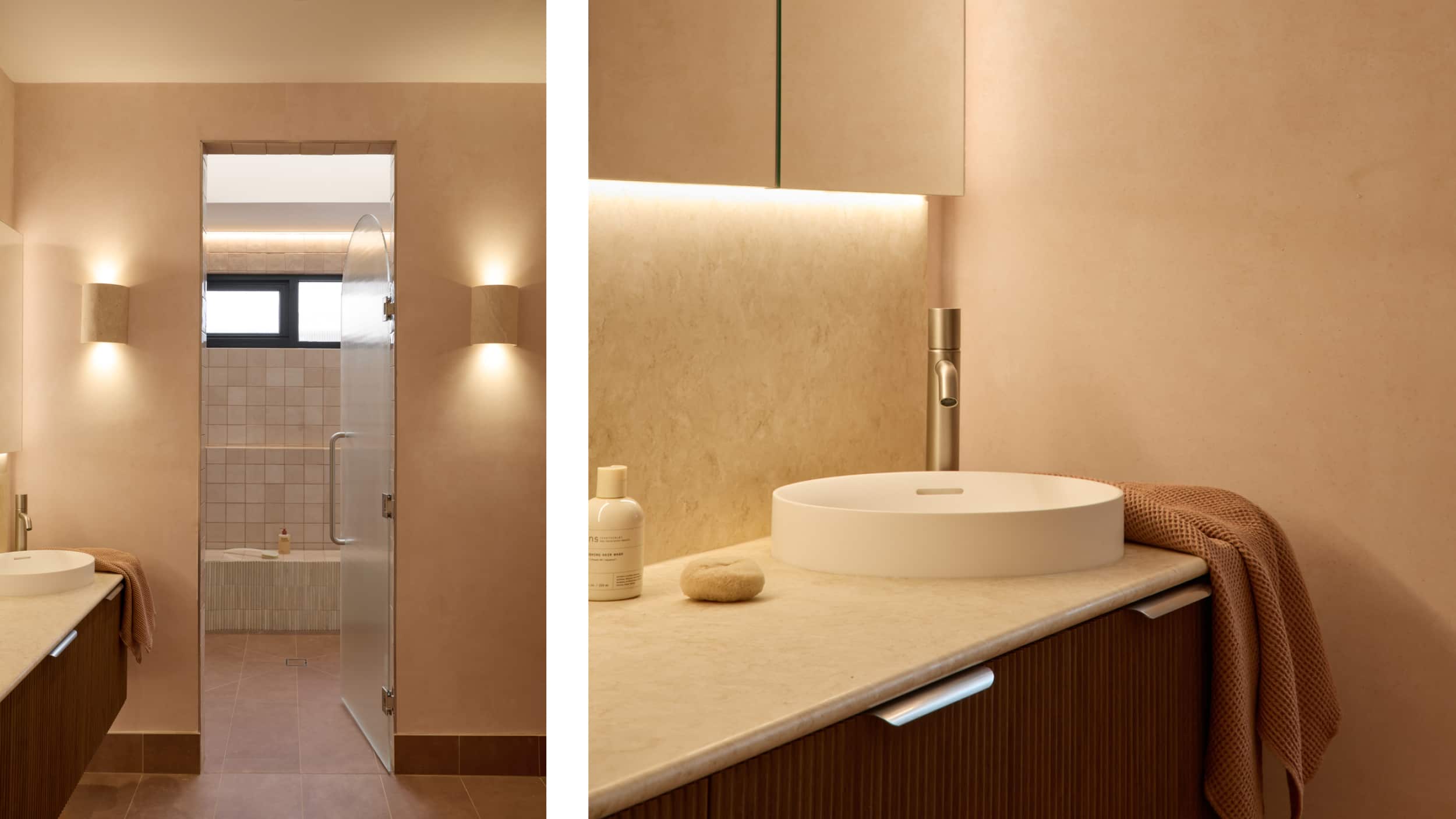 A spa-like bathroom featuring blush tones, timber vanity, white above counter basins, soft lighting, and a walk in shower area