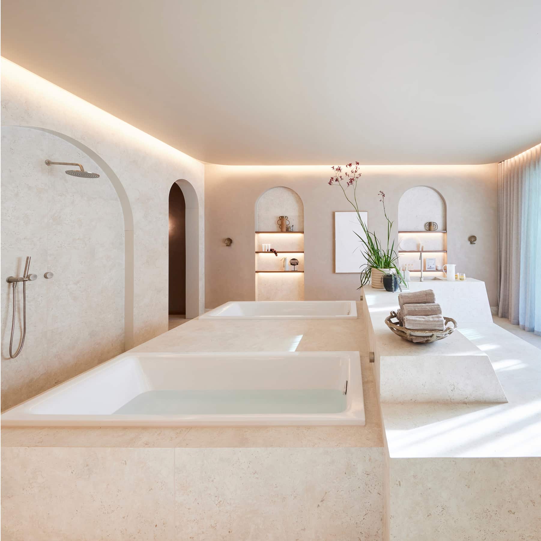 A bright and airy bathroom including bath, shower and large windows
