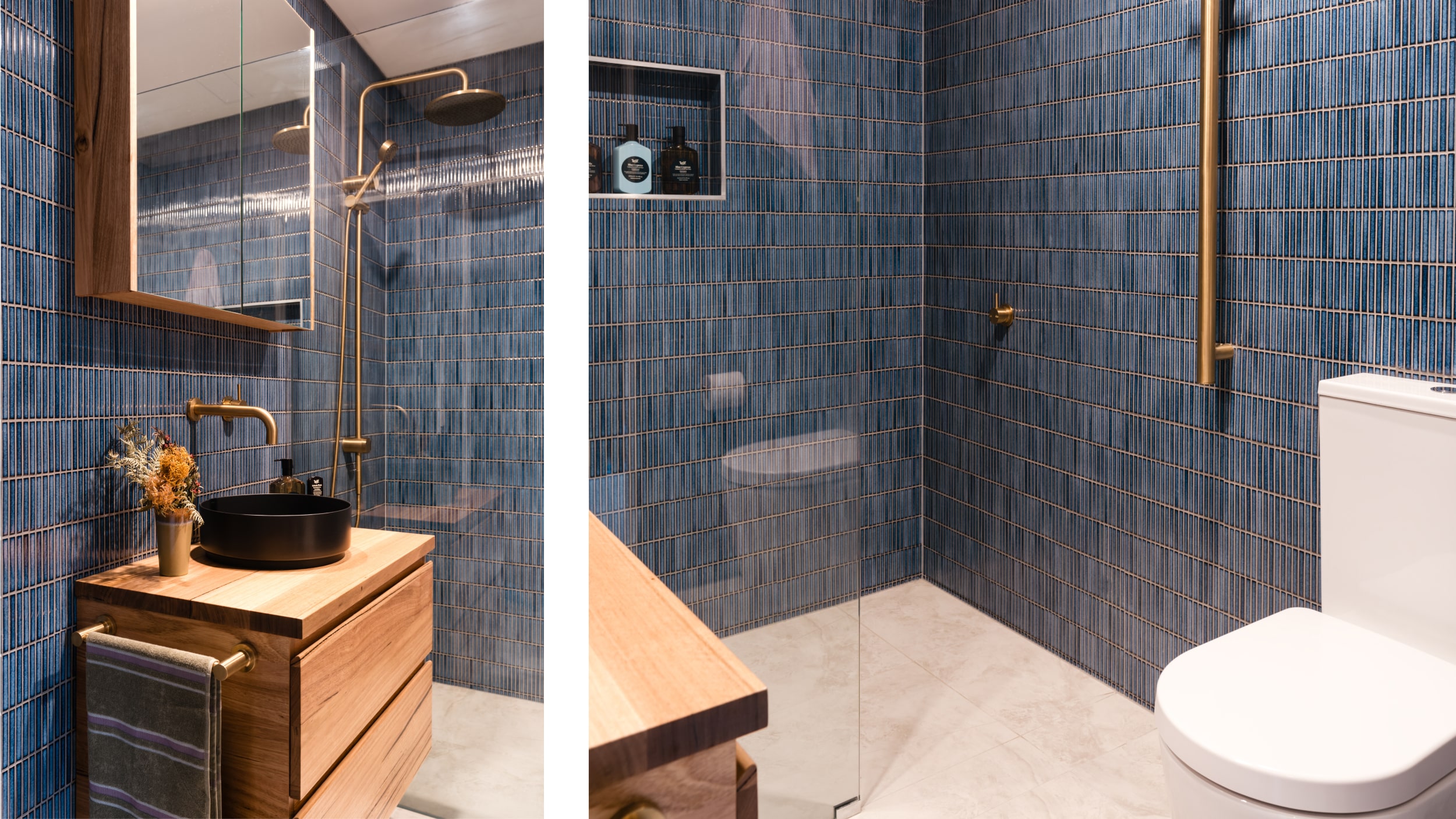 A modern bathroom featuring timber vanity, blue tiled walls, black basin, brushed tapware and toilet.