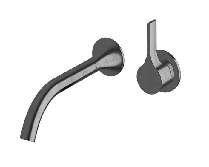 A wall basin outlet and mixer in brushed gunmetal