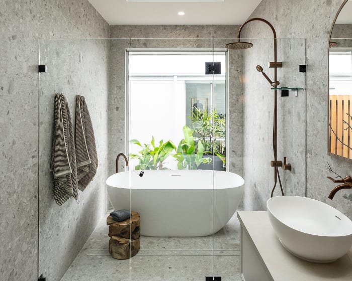 A contemporary bathroom showcasing a glass shower door next to a relaxing bathtub.