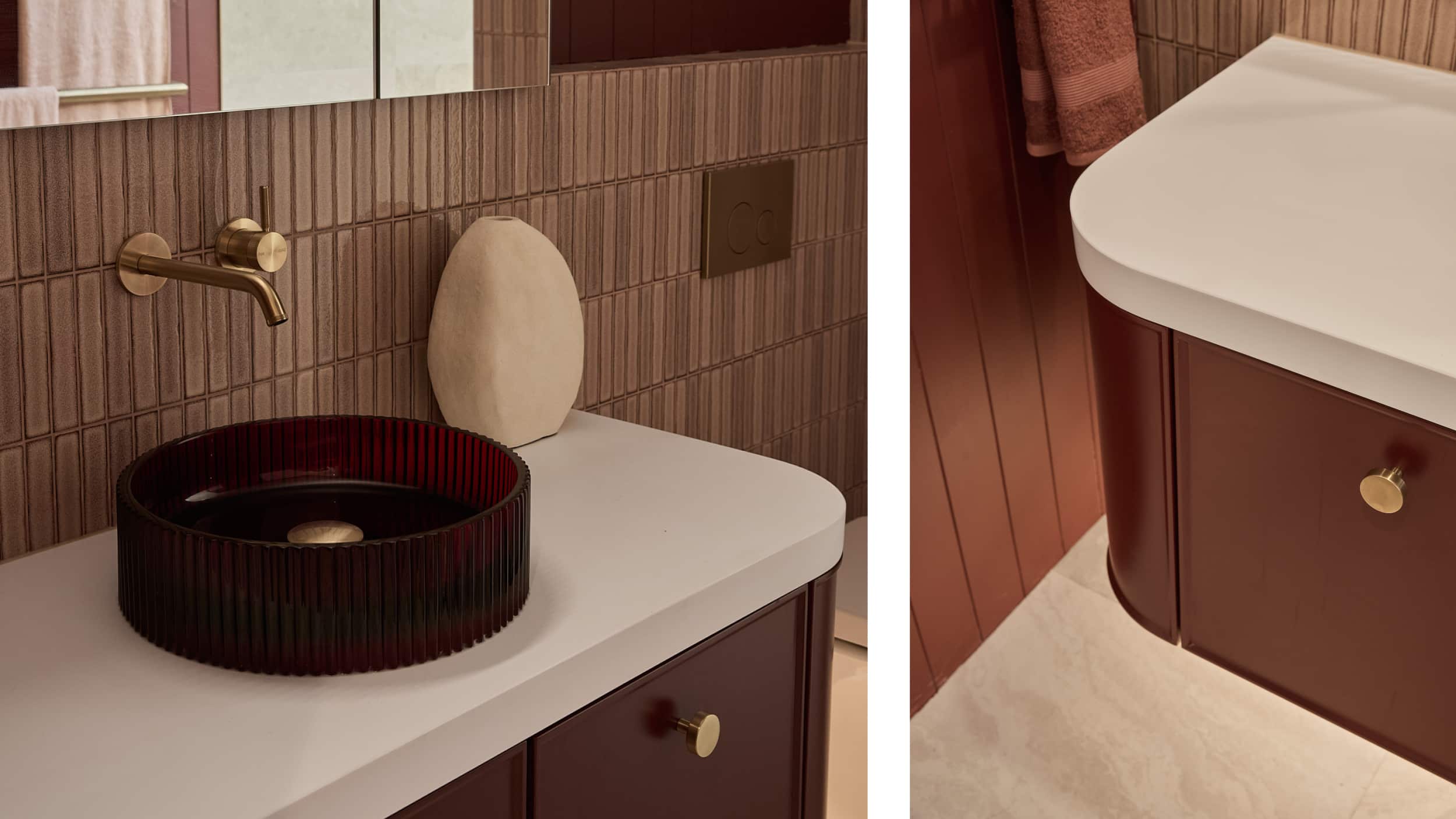A modern bathroom with maroon vanity and basin, white countertop and gold tapware