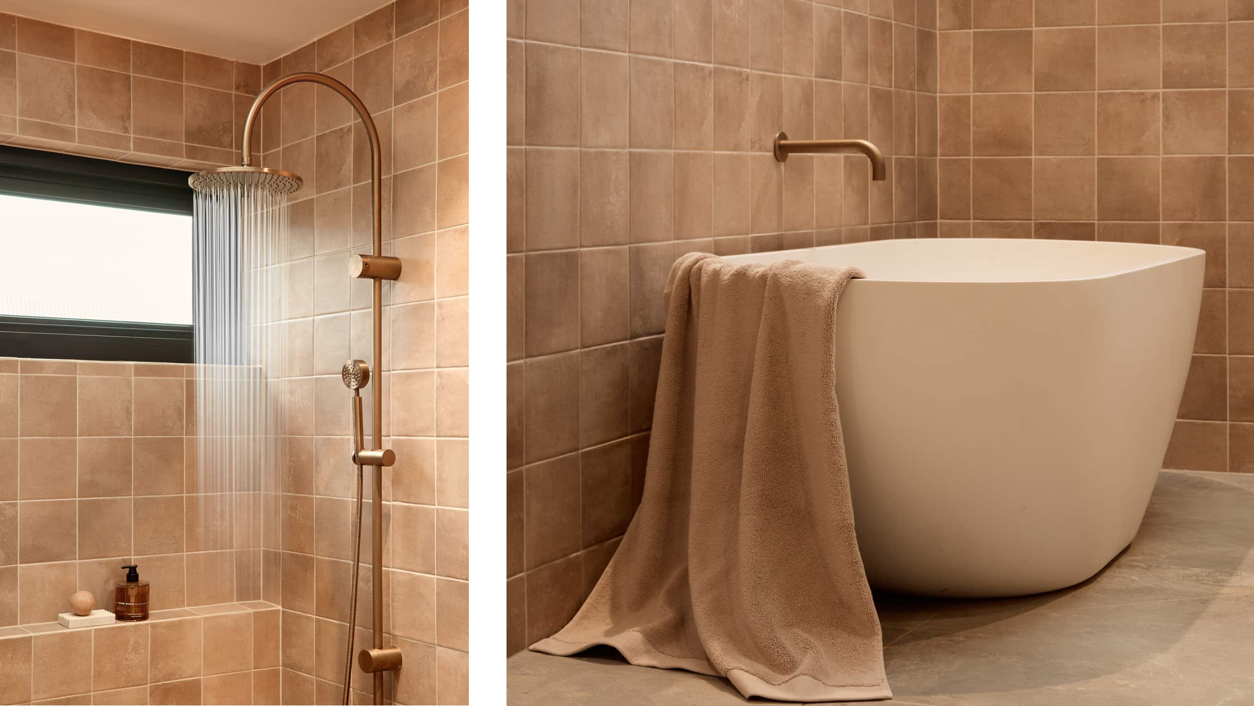 A spa-like bathroom featuring freestanding bath and expansive shower, both with brushed bronze tapware, and styled with accessories