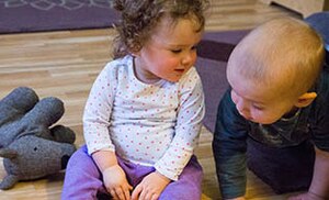 Two children laying on the floor
