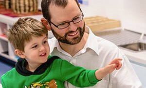 Educator and child pointing